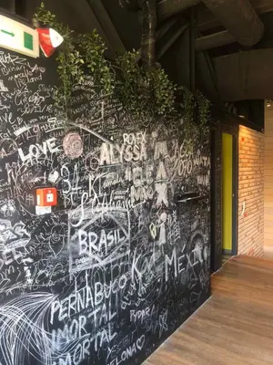 a wall covered in graffiti and writing on a wall at Iconic Athens Hostel in Athens
