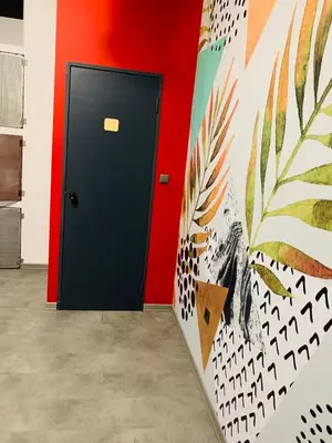 a black door in a room with a colorful wall at Iconic Athens Hostel in Athens