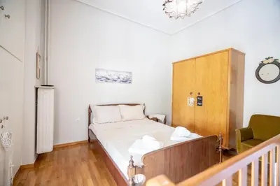 a small bedroom with a bed and a cabinet at Family apartment at Kalithea 2 bedrooms 4 pers in Athens