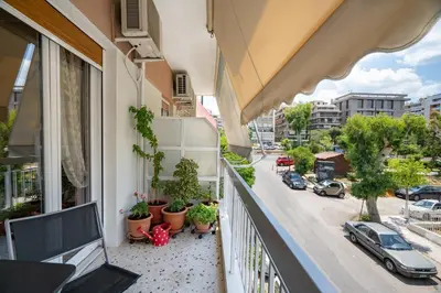a balcony of a building with potted plants and a street at Family apartment at Kalithea 2 bedrooms 4 pers in Athens