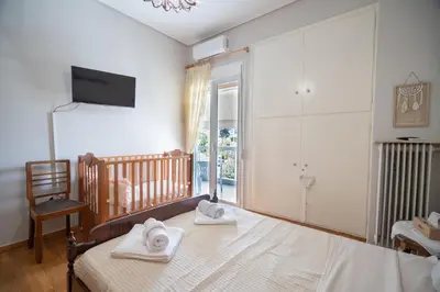 a bedroom with a bed with towels on it at Family apartment at Kalithea 2 bedrooms 4 pers in Athens