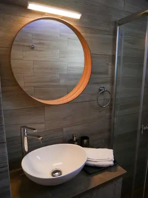 a bathroom with a white sink and a mirror at Lux Sea Apartment - Porto Rafti in Porto Rafti