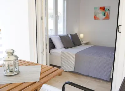 a small room with a bed and a table at Lux Sea Apartment - Porto Rafti in Porto Rafti