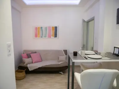 a living room with a couch and a table at Lux Sea Apartment - Porto Rafti in Porto Rafti