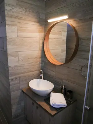 a bathroom with a sink and a mirror at Lux Sea Apartment - Porto Rafti in Porto Rafti