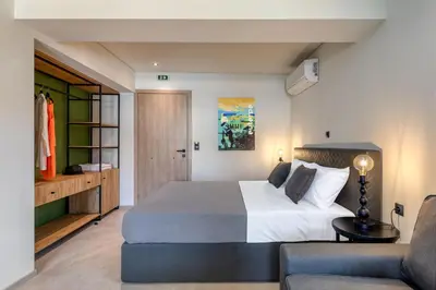 a bedroom with a large bed and a couch at Muse Urban Suites in Athens