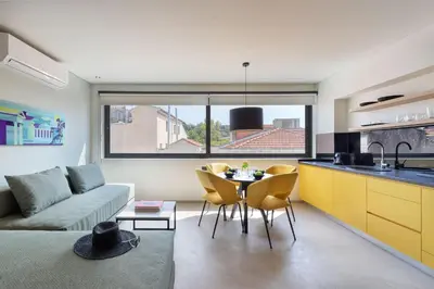 a kitchen and living room with a couch and a table at Muse Urban Suites in Athens