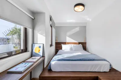 a bedroom with a bed and a window at Filopappou Hill Suites by Athens Stay in Athens