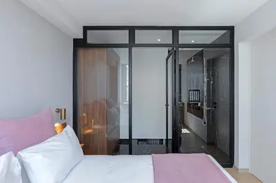 a bedroom with a bed and a walk in shower at Filopappou Hill Suites by Athens Stay in Athens
