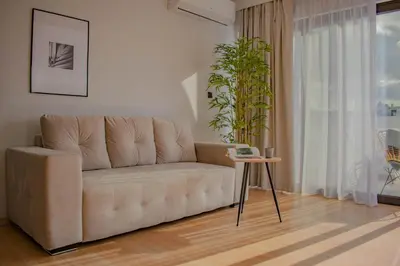 a living room with a couch and a table at Filopappou Hill Suites by Athens Stay in Athens