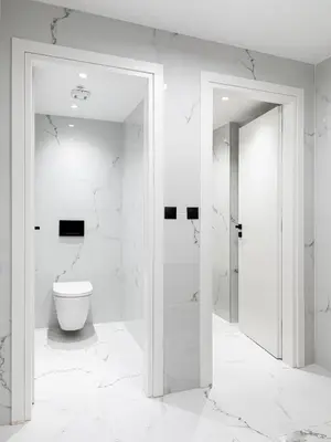 a white bathroom with a toilet and a glass door at Filopappou Hill Suites by Athens Stay in Athens