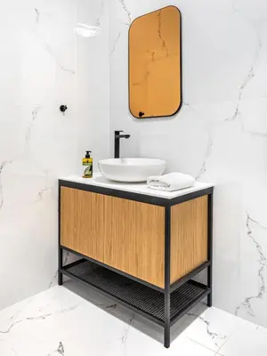 a bathroom with a sink and a mirror at Filopappou Hill Suites by Athens Stay in Athens