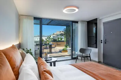 a bedroom with a bed and a view of a balcony at The Newel Acropolis in Athens