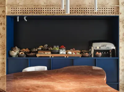 a dining room with blue cabinets and a table at The Newel Acropolis in Athens