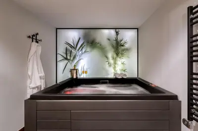 a bath tub in a bathroom with a painting of plants at The Newel Acropolis in Athens