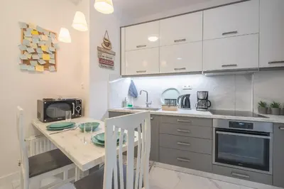 a kitchen with a table and a microwave at Earthy Green House in Athens