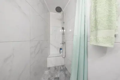 a bathroom with a shower with a shower curtain at Earthy Green House in Athens