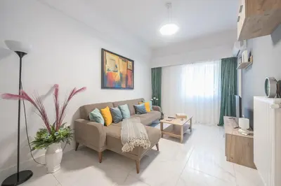 a living room with a couch and a table at Earthy Green House in Athens