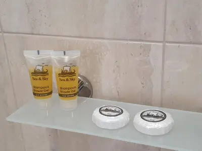two glasses sitting on a shelf in a bathroom at City Center Athenes rooms in Athens