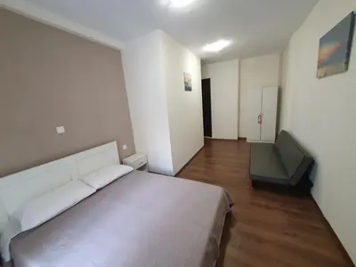 a bedroom with a large white bed and a couch at City Center Athenes rooms in Athens