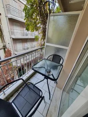 a balcony with two chairs and a table on it at City Center Athenes rooms in Athens