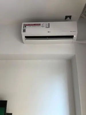 a white air conditioner on the ceiling of a room at Metropolitan Complex room-Faliro in Piraeus