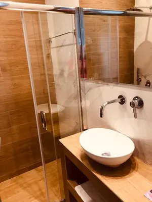 a bathroom with a sink and a shower at Metropolitan Complex room-Faliro in Piraeus
