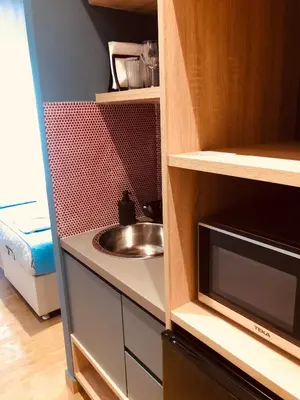 a kitchen with a sink and a microwave at Metropolitan Complex room-Faliro in Piraeus