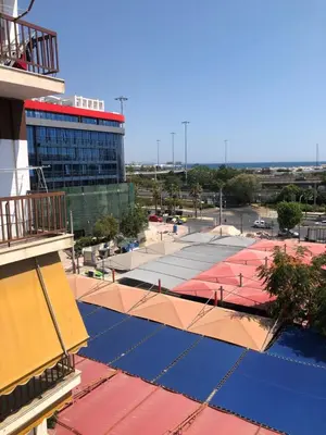 a view of a building with a tennis court at Metropolitan Complex room-Faliro in Piraeus