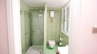 a bathroom with a shower and a toilet and a sink at quiet and central FLAT with private backyard GARDEN in Athens