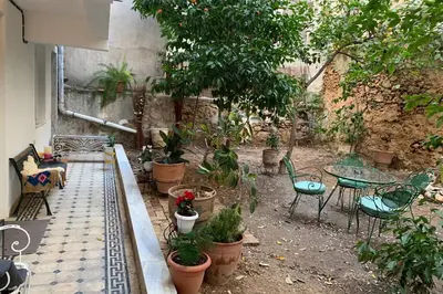 a garden with a table and chairs and potted plants at quiet and central FLAT with private backyard GARDEN in Athens