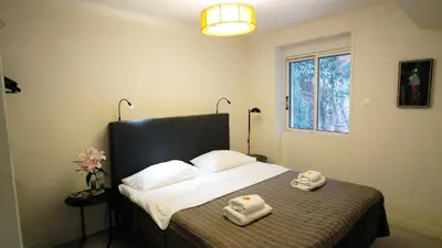 a bedroom with a bed with two towels on it at calm and cozy flat with romantic garden in Athens