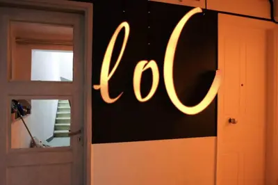 a sign on a wall next to a door at calm and cozy flat with romantic garden in Athens