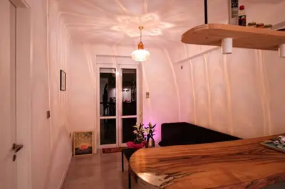 a room with a bed and a window and a ceiling at calm and cozy flat with romantic garden in Athens