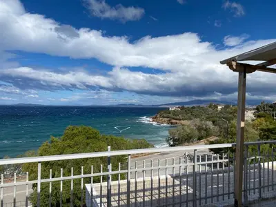 a view of the ocean from the balcony of a house at Waterfront Penthouse in Saronida