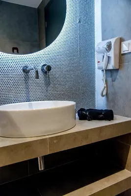 a bathroom with a sink and a mirror at CentraL44 WoW CasuaL Suite-Ermou view in Athens