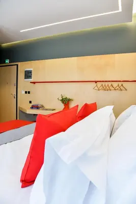a bedroom with two beds with red pillows at CentraL44 OMG Casual Suite-Ermou view in Athens