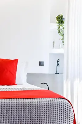 a bedroom with a bed with a red pillow at CentraL44 OMG Casual Suite-Ermou view in Athens