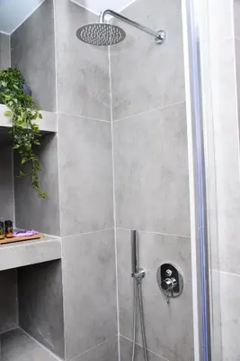 a shower with a glass door in a bathroom at CentraL44 OMG Casual Suite-Ermou view in Athens