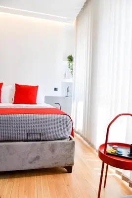 a bedroom with a bed and a red table at CentraL44 OMG Casual Suite-Ermou view in Athens