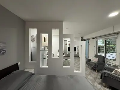 a bedroom with a bed and a living room at Aphrodite Studio near Athens Floisvos Marina in Athens