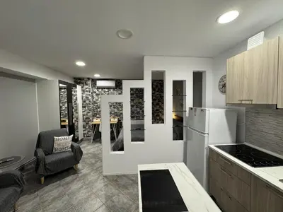 a kitchen with a refrigerator and a dining room at Aphrodite Studio near Athens Floisvos Marina in Athens