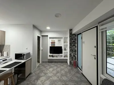 a kitchen with white walls and a large window at Aphrodite Studio near Athens Floisvos Marina in Athens
