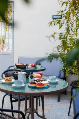 a table with plates of food on it at Acropolis Vision in Athens