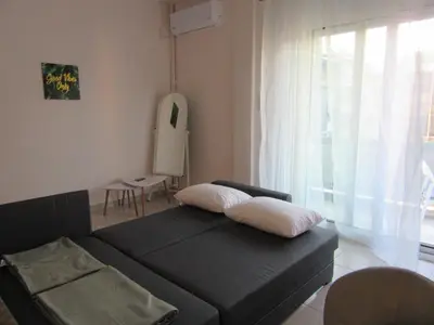 a bedroom with a black bed with two pillows on it at ΜΕ ΘΕΑ ΤΟ ΛΙΜΑΝΙ in Piraeus