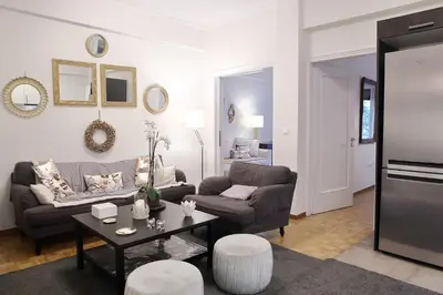 a living room with a couch and a table at VZ Athens Apartment in Athens
