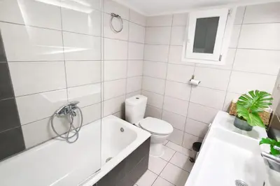 a bathroom with a toilet and a tub and a sink at Comfortable Modern Entire House near the center of Athens-Blue Serenity in Athens
