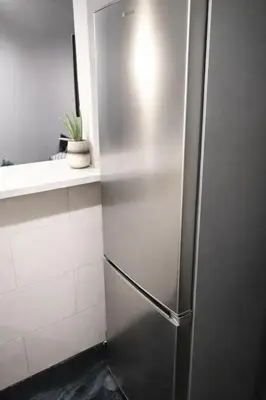 a stainless steel refrigerator in a kitchen at Comfortable Modern Entire House near the center of Athens-Blue Serenity in Athens