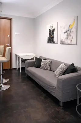 a living room with a couch and a table at Comfortable Modern Entire House near the center of Athens-Blue Serenity in Athens