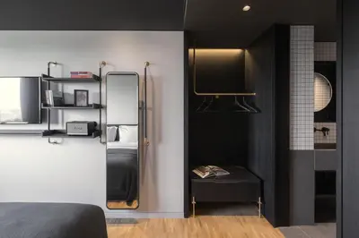a bedroom with a mirror and a bed and a table at The Modernist Athens in Athens
